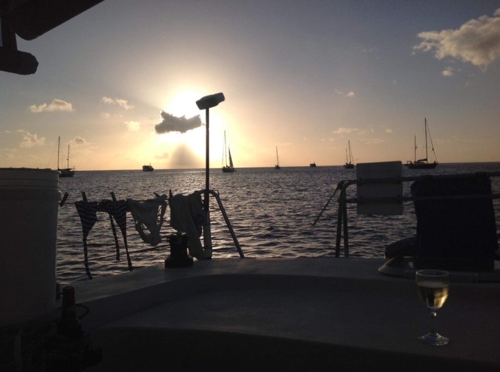 Sunset, sailboats, bikini laundry line, tropical scene